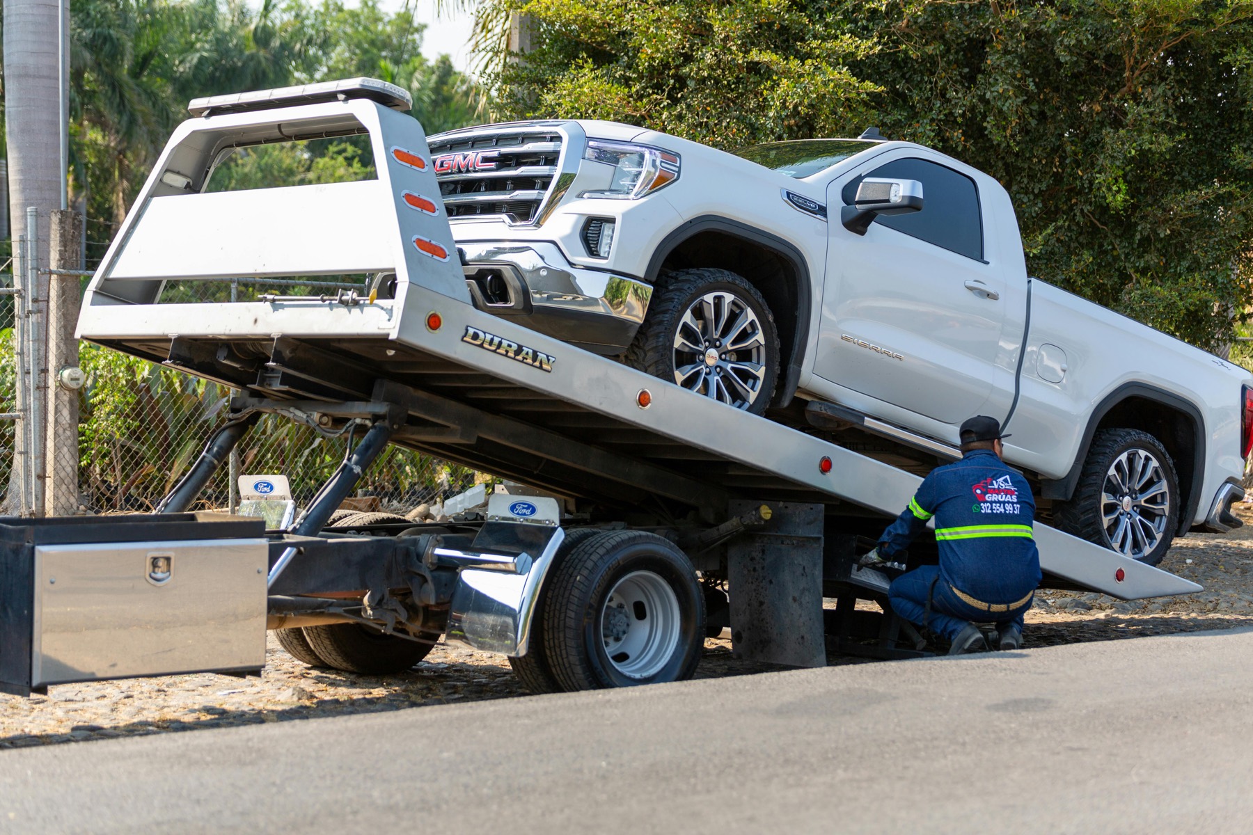 Tow truck loading a vehicle for pickup